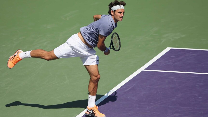 Switzerland's Roger Federer serves against Ivo Karlovic of Croatia at the Miami Masters.