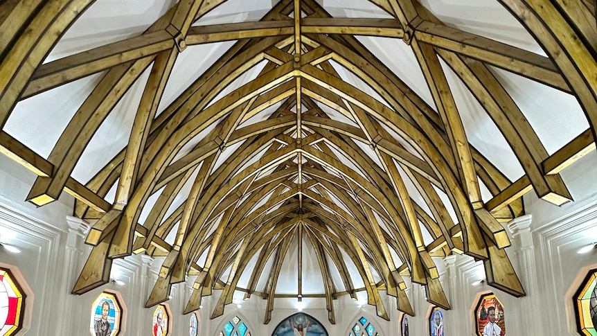 Wooden vaults, with stained glass windows underneath, at a church in Lepea.