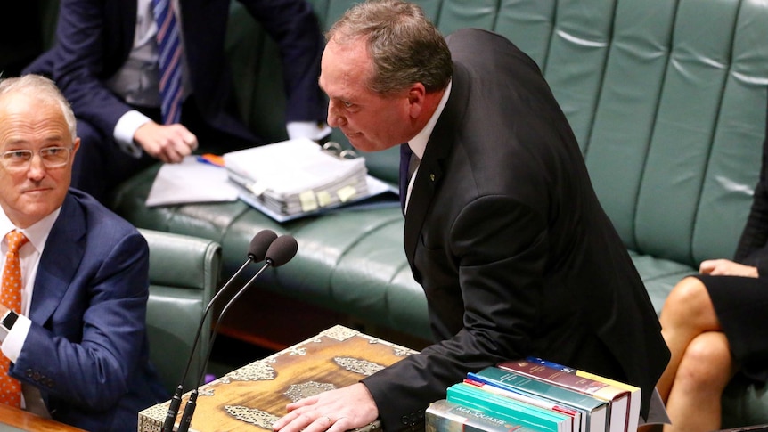 Barnaby Joyce leaning over desk in parliament