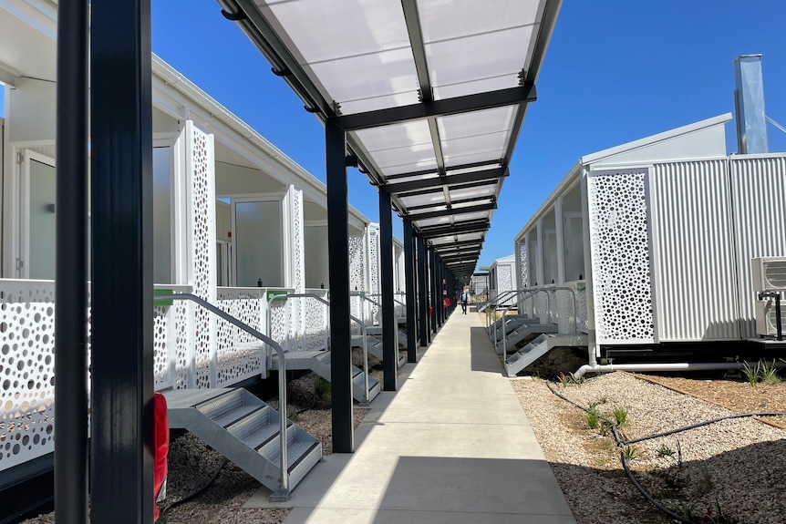 An outdoor walkway near cabins designed for quarantine