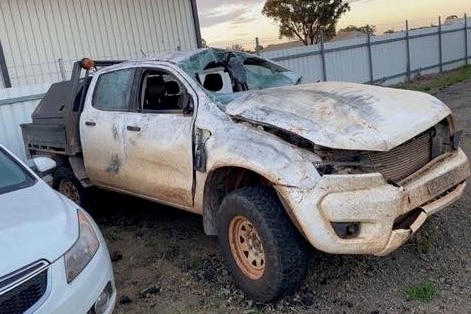 white ute with smashed bonnet, windscreen and windows.
