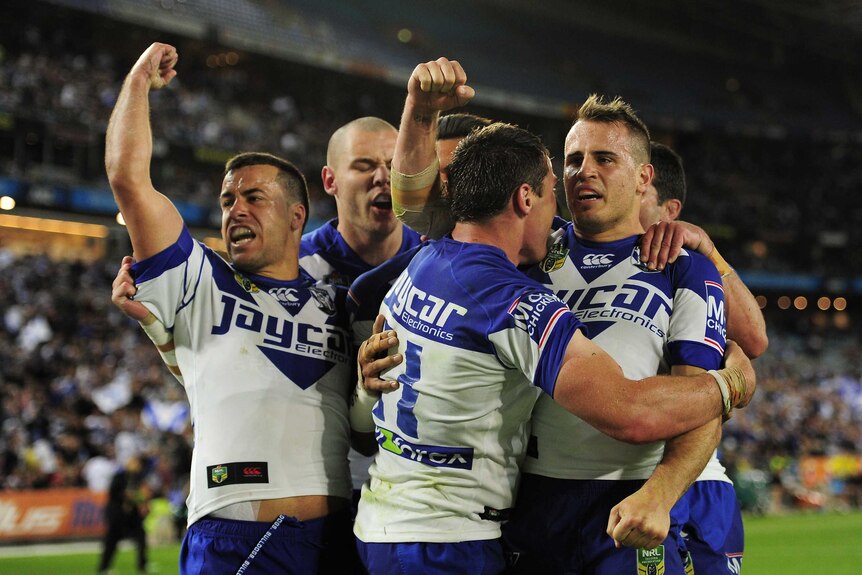 Bulldogs players celebrate a try