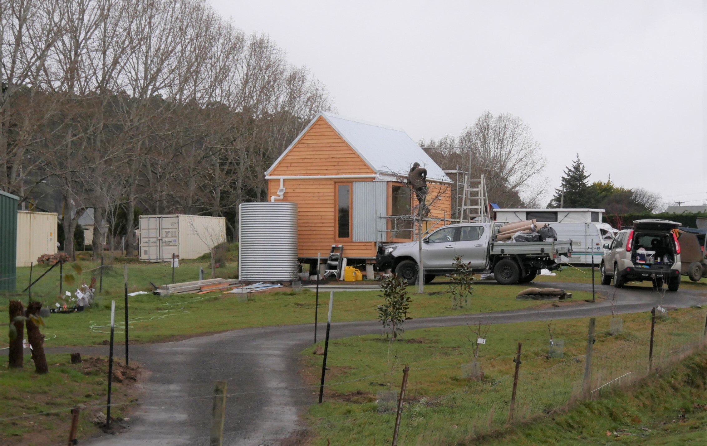 Small home being built at the end of a drive way.