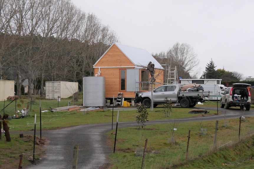 Small home being built at the end of a drive way.