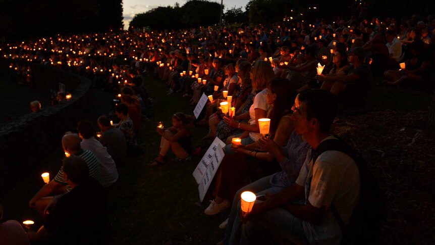People take part in a candlelight vigil in support of asylum seekers in Brisbane.