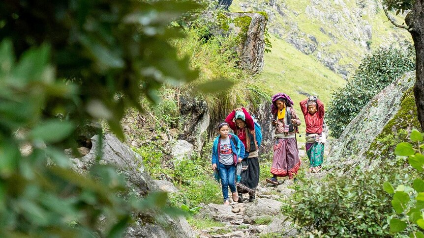 Devi and her family walking home along the trails.