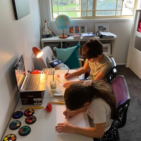 Two students participating in school from home.