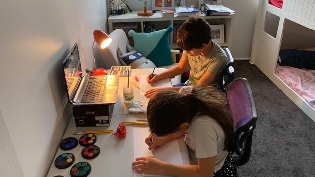 Two students participating in school from home.