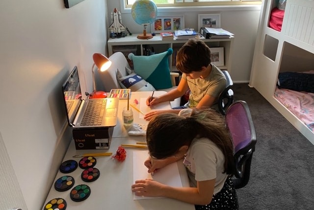 Two students participating in school from home.