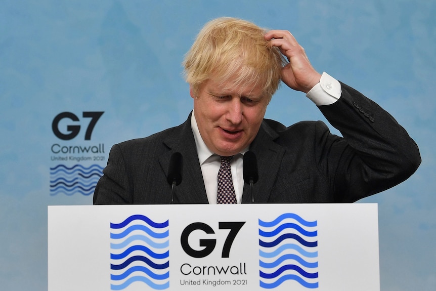 Prime Minister Boris Johnson gestures, during a press conference on the final day of the G7 summit
