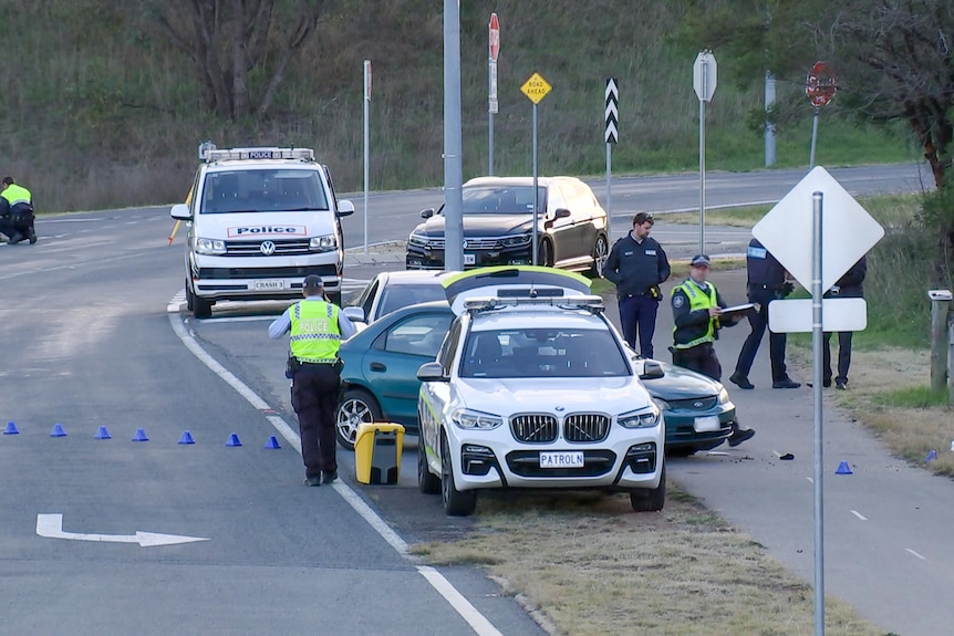 Police and police cars at an accident scene. 
