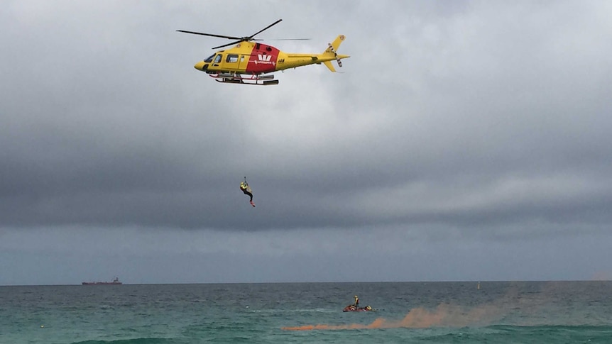 A man is winched out of the sea