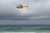 A man is winched out of the sea