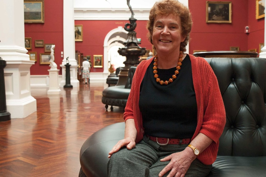 Prof Catherine Speck sitting in the Art Gallery of South Australia.