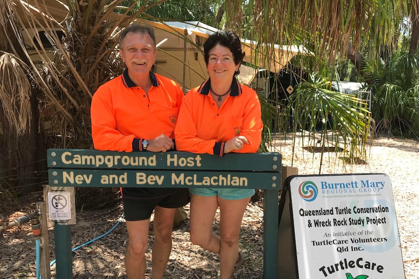 Bev and Nev McLachlan with a 'turtle crossing' sign at their Wreck Rock campsite