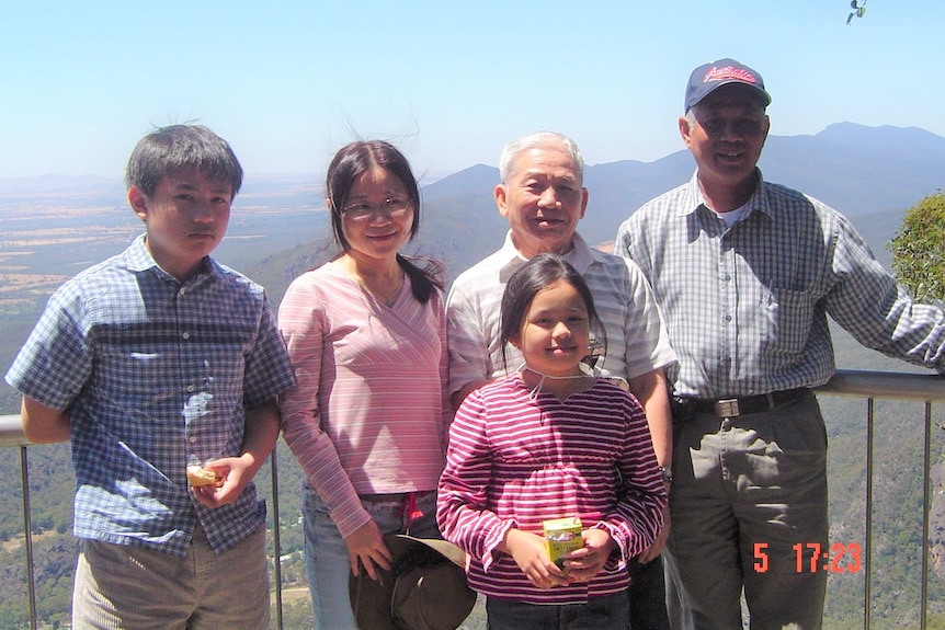 A family photo of a Vietnamese Australian family overlooking a look-out.