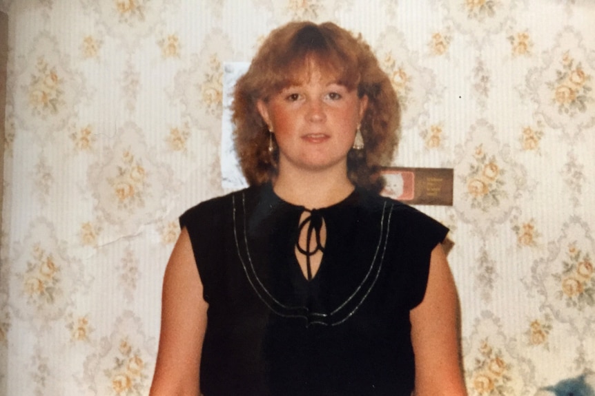 A teenage girl pictured in 1981 against a wallpaper background.