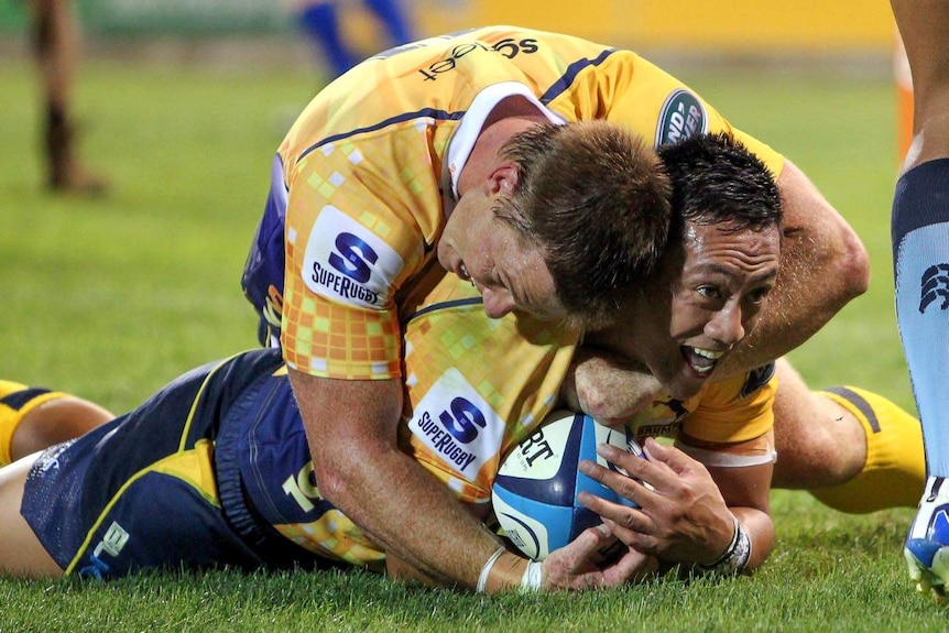 Christian Lealiifano is hugged after scoring a try during the Brumbies win.
