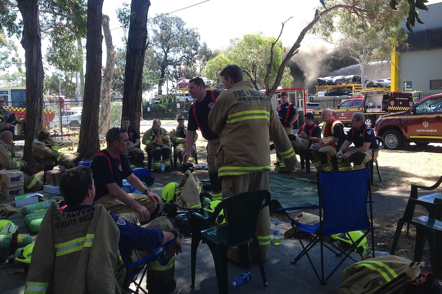 Firefighters take a rest at Revesby fire