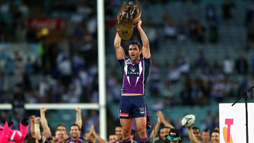 Cameron Smith lifts the NRL premiership trophy.