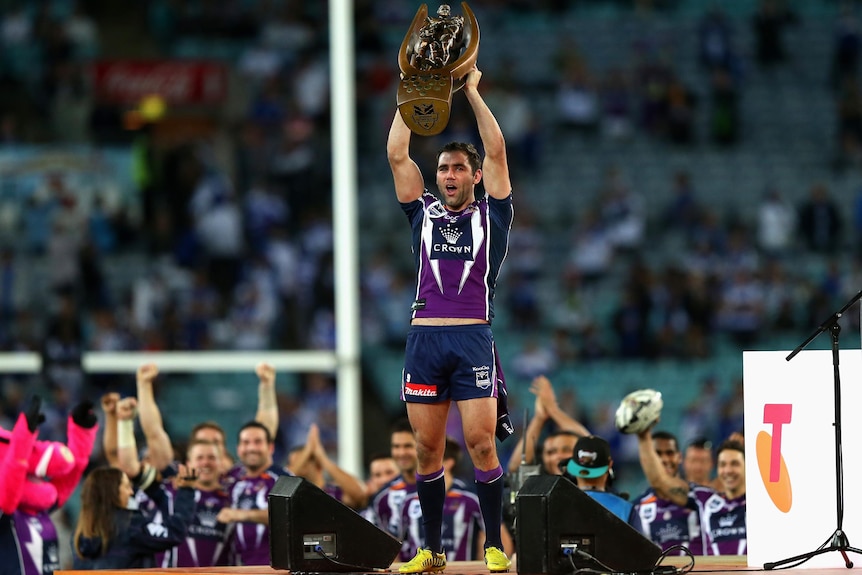 Cameron Smith lifts the NRL premiership trophy.