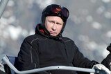 Vladimir Putin and Dmitry Medvedev ride in a ski cable car cabine near Sochi.
