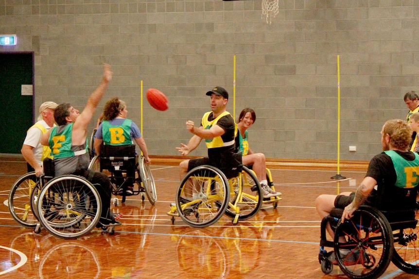 Larry Elphinstone handballing the ball over his brother Jamie on the court in Somerset