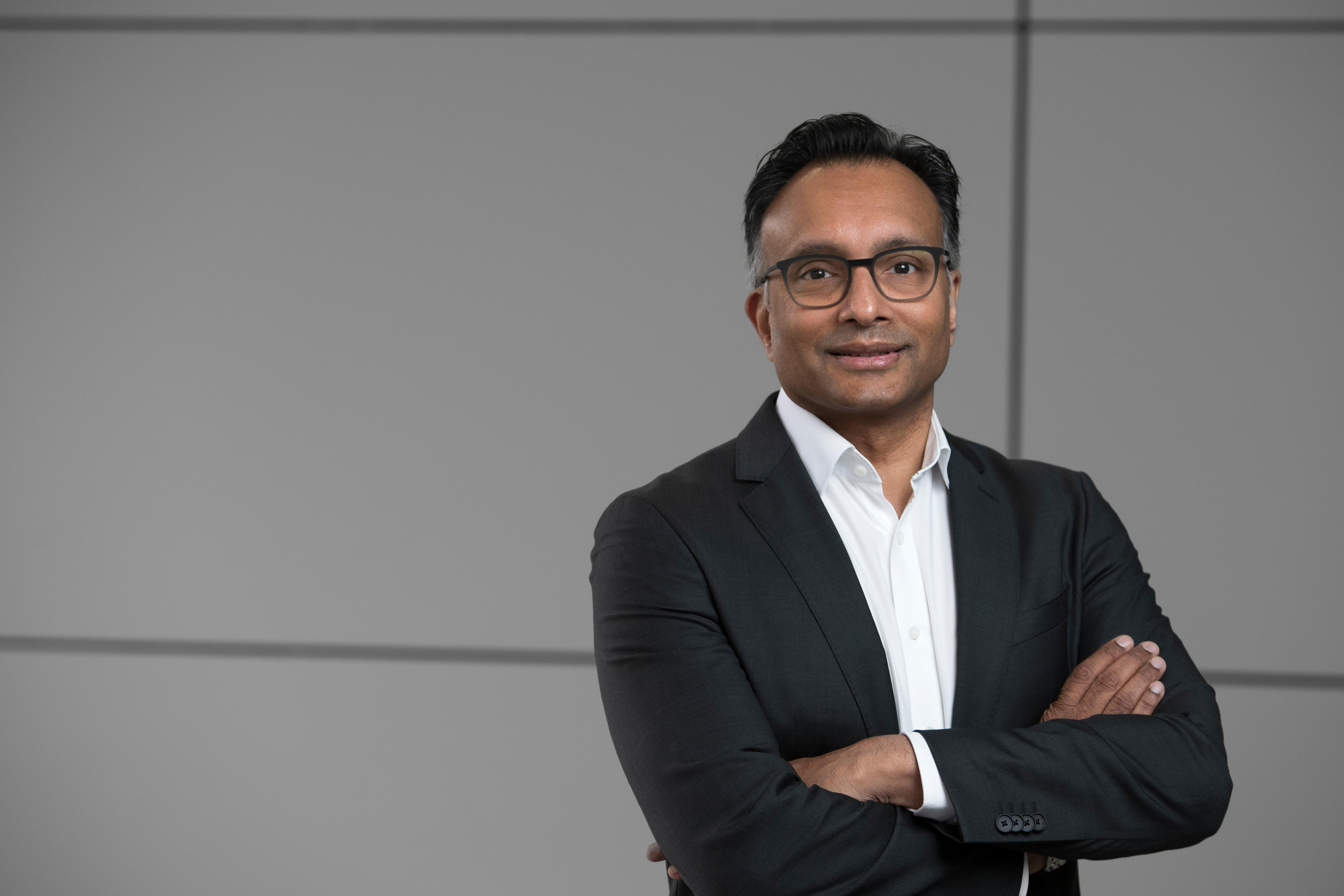 Man with folded arms facing the camera.