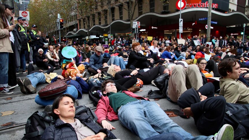 Protesters lying in the street in Melbourne as part of a climate protest.
