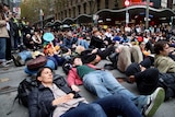 Protesters lying in the street in Melbourne as part of a climate protest.