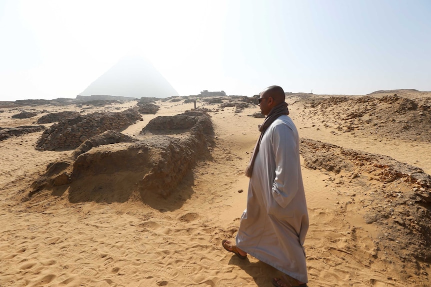 A man walks near a discovery from Egypt’s antiquities authorities at the Giza plateau.