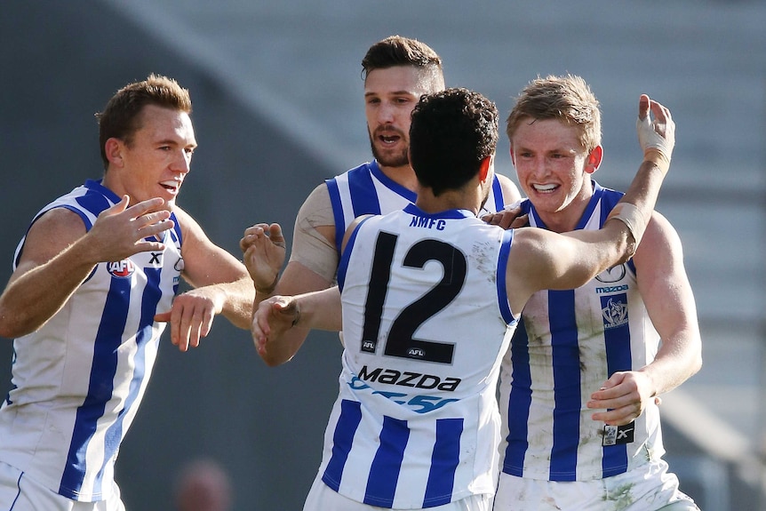 Kangaroos' Jack Ziebell celebrates with team-mates after his goal against Adelaide in Hobart.