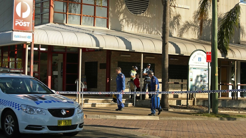 Police set up a crime scene where a man was shot at Warners Bay