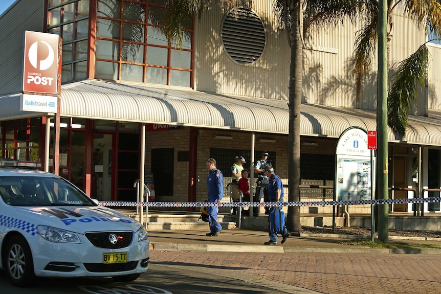 Police set up a crime scene where a man was shot at Warners Bay