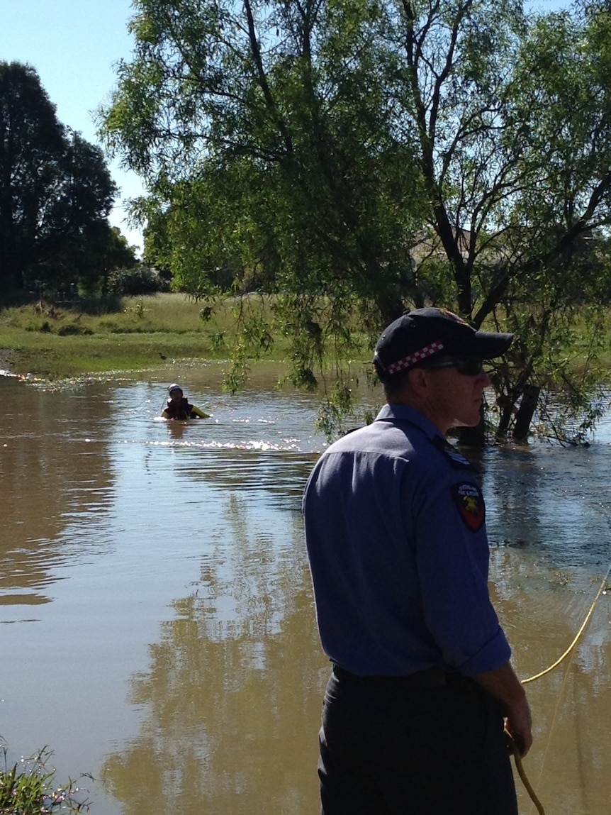 Rescue crews search for a woman missing in floodwaters in Roma.