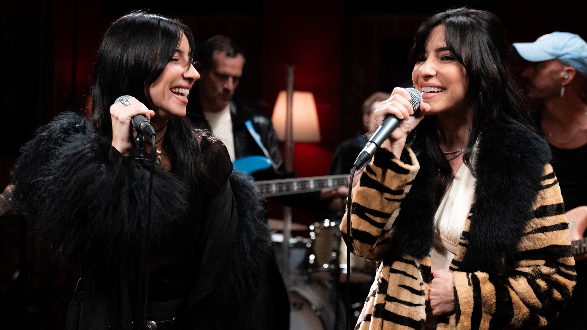 Jess and Lisa of The Veronicas smile while performing in the Like A Version studio