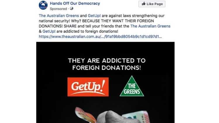A Facebook ad, posted by 'Hands Off Our Democracy', with text, Get Up and The Greens logo and a fist clenching cash.