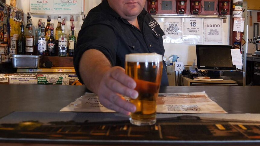 A publican serving a beer.