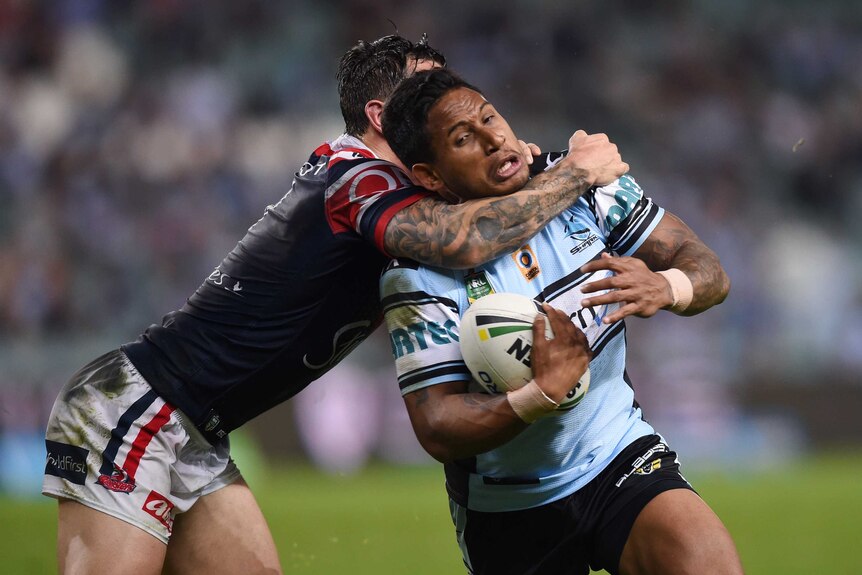 The Sharks' Ben Barba is tackled by Mitchell Pearce of the Roosters