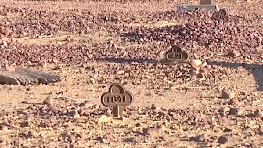 Headstones with numbers in cemetery