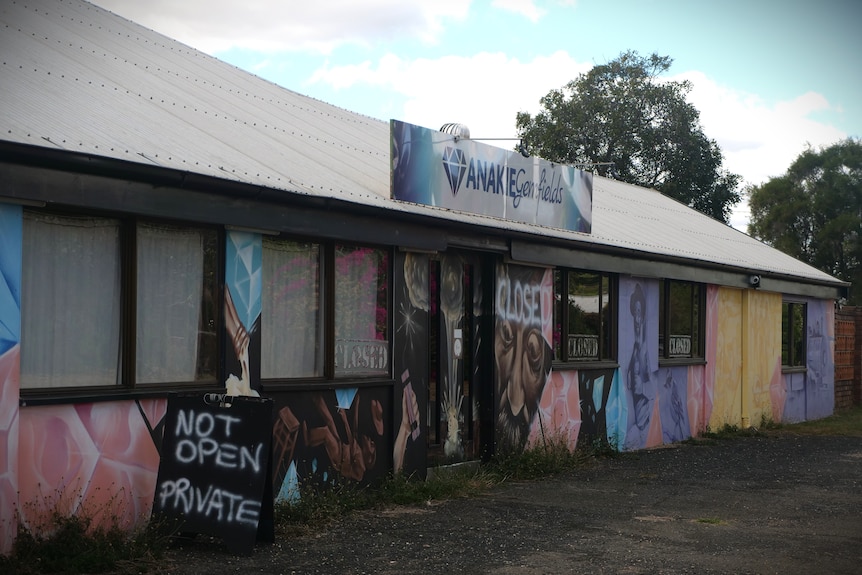 A building with painting on the outside and a sign saying 'not open, private'
