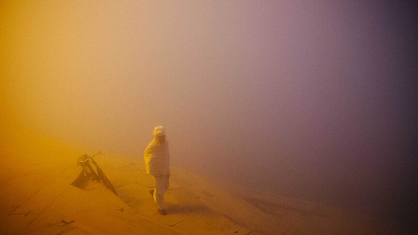 Man stands in fog mist in India