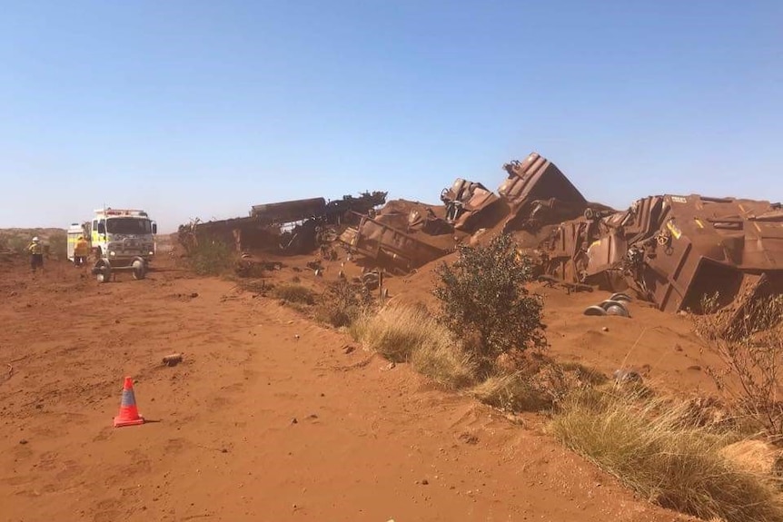 Iron ore train carriages strewn across the railway after it was deliberately derailed.