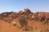 Iron ore train carriages strewn across the railway after it was deliberately derailed.