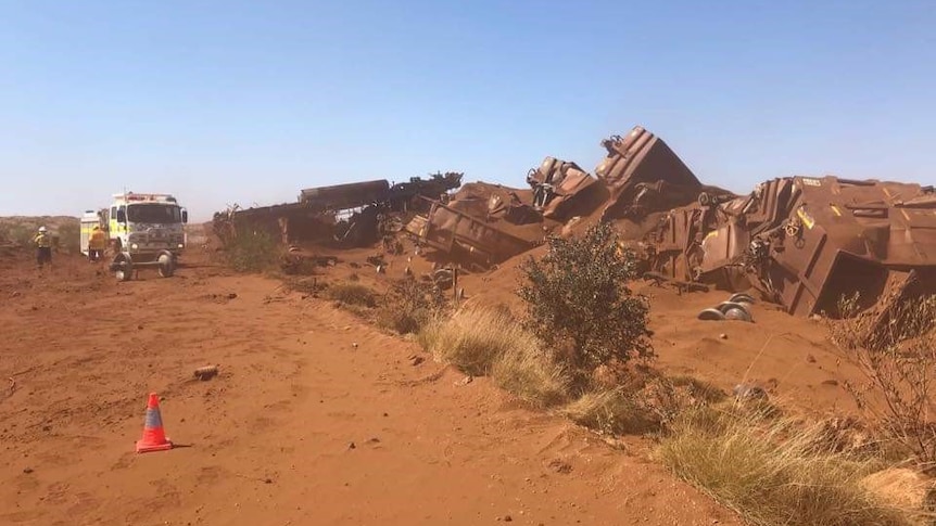 Iron ore train carriages strewn across the railway after it was deliberately derailed.
