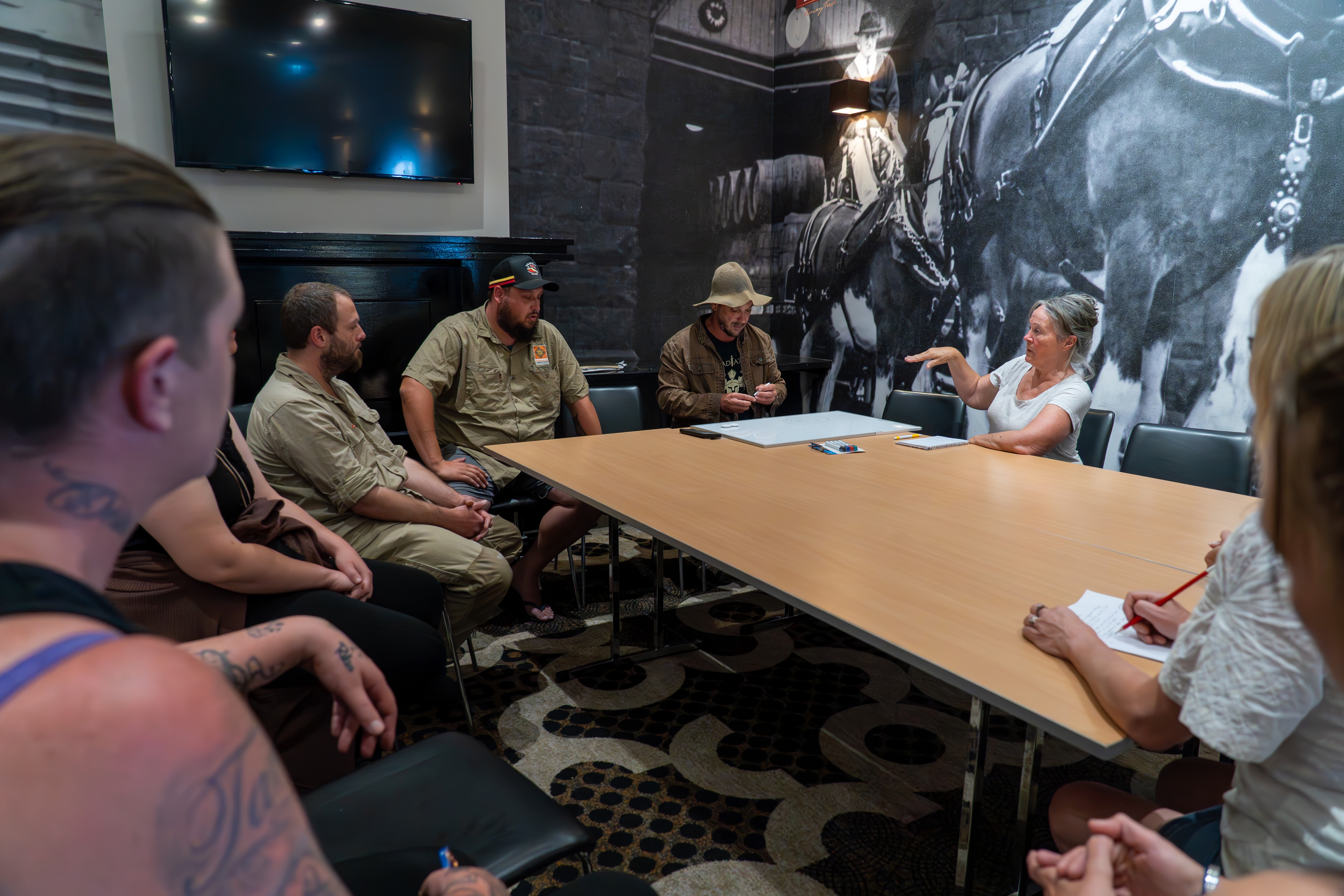 A group of people sit around a table. 