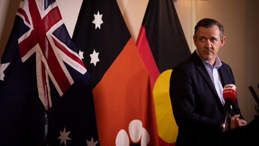 Michael Gunner stands at a lectern during a COVID press conference.