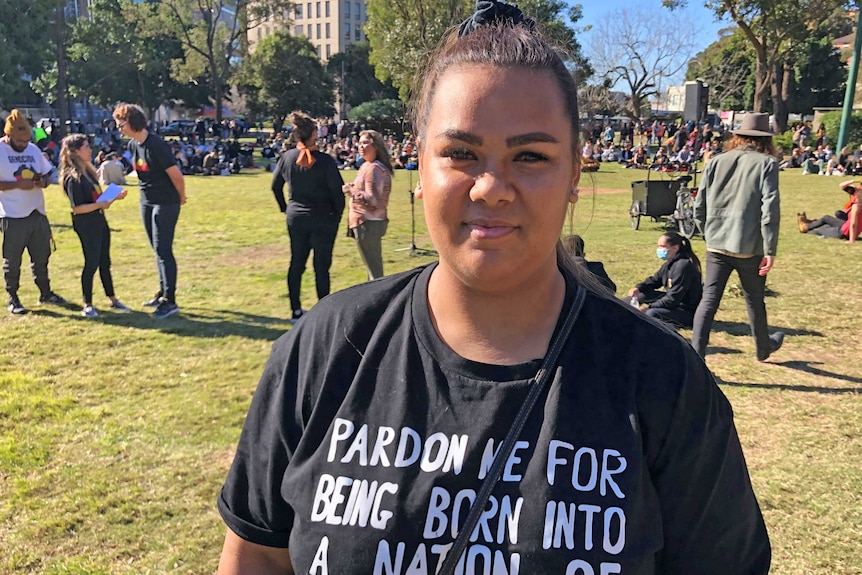 A woman in a black T-shirt in a park