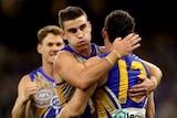West Coast Eagles midfielder Luke Shuey, with his back turned, is hugged by teammate Elliot Yeo after scoring a goal.