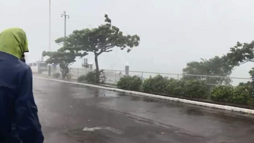 A lady watches rain on Thursday Island